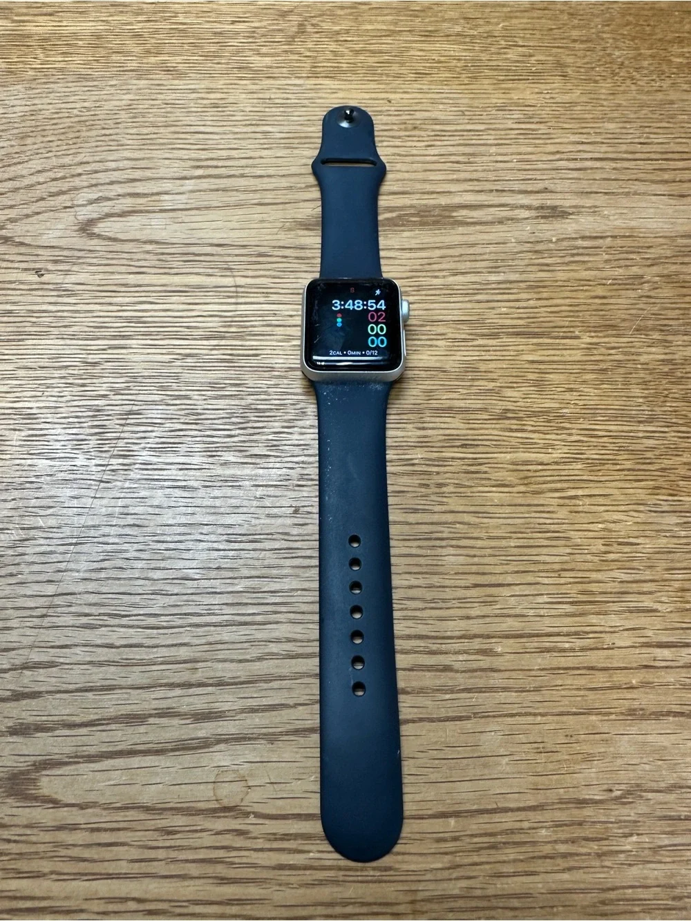 Apple Watch Series 3 with Black and White bands and charging cable.